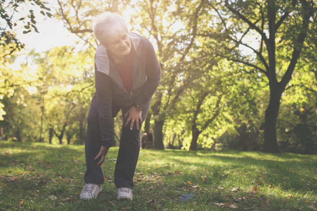 Senior woman experiencing peripheral artery disease symptoms in the legs