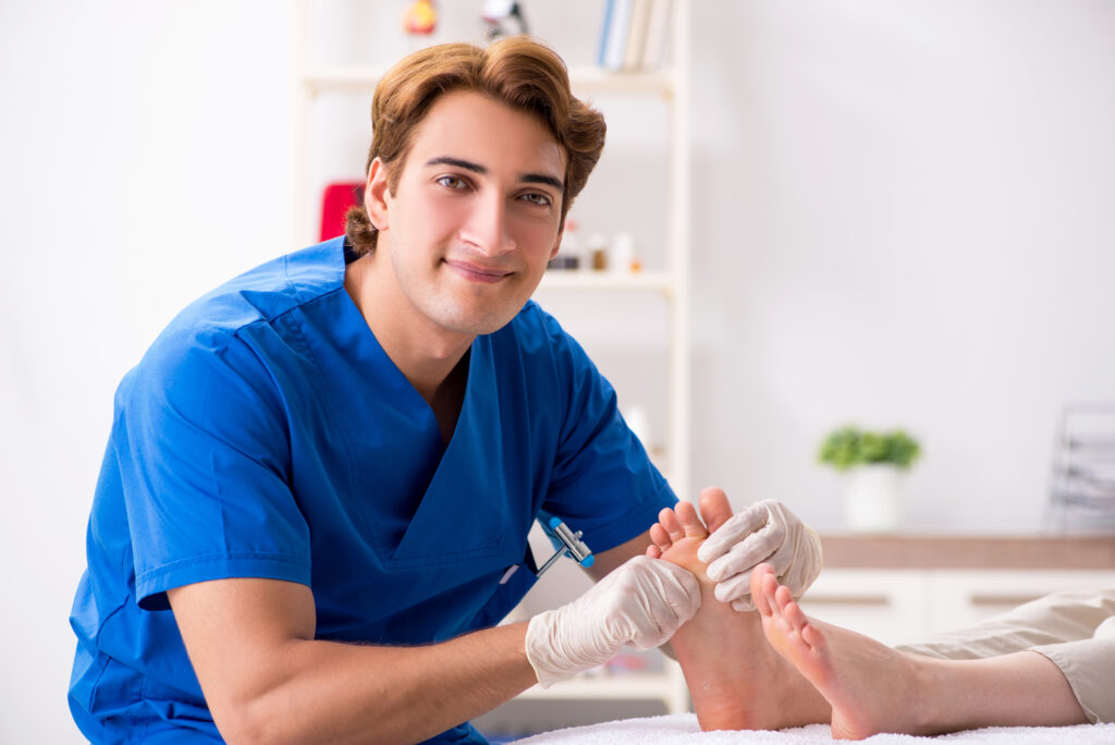 Doctor examining patient feet for leg diseases