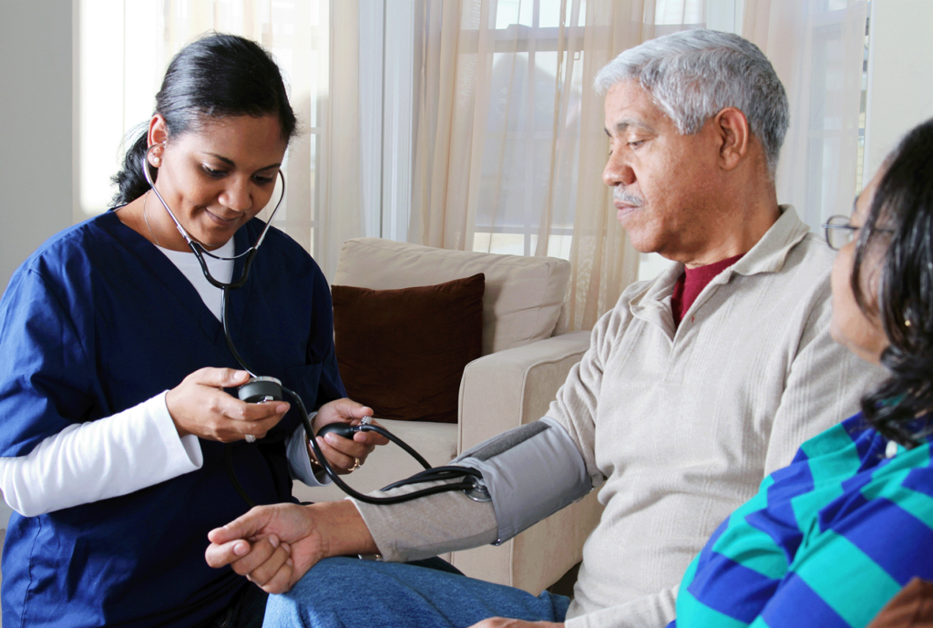 Minority health. Black man gets blood pressure taken by healthcare provider