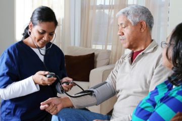 Minority health. Black man gets blood pressure taken by healthcare provider