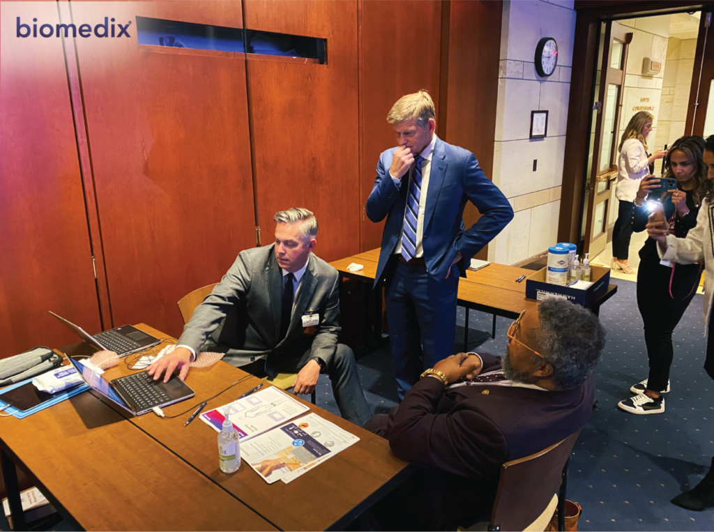 Chris Trygstad tests Representative Donald Payne Jr. while Dr. John Martin looks on